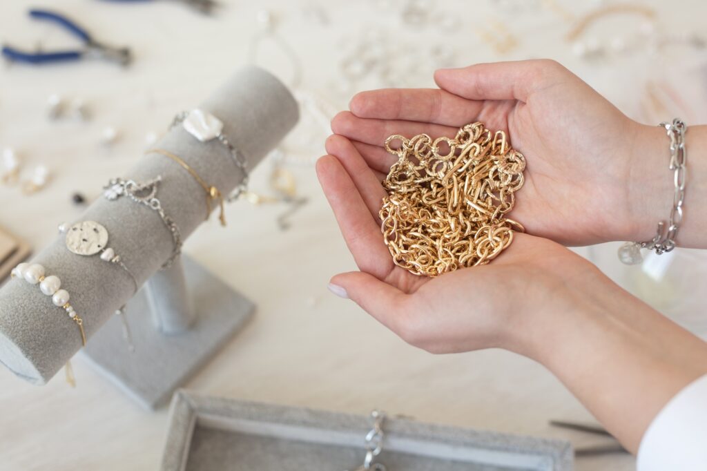 Professional jewelry designer making handmade jewelry in studio workshop. Fashion, creativity and